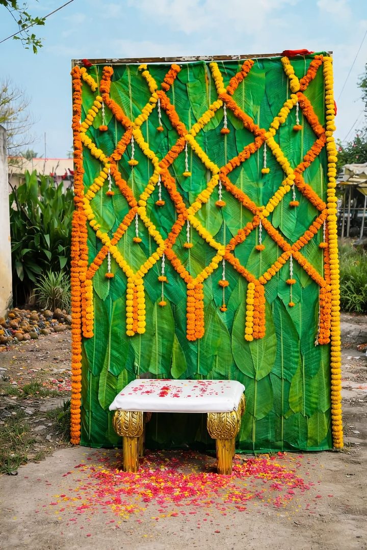 Haldi decoration with banana-leaf backdrop and marigold lattice by GK Signature