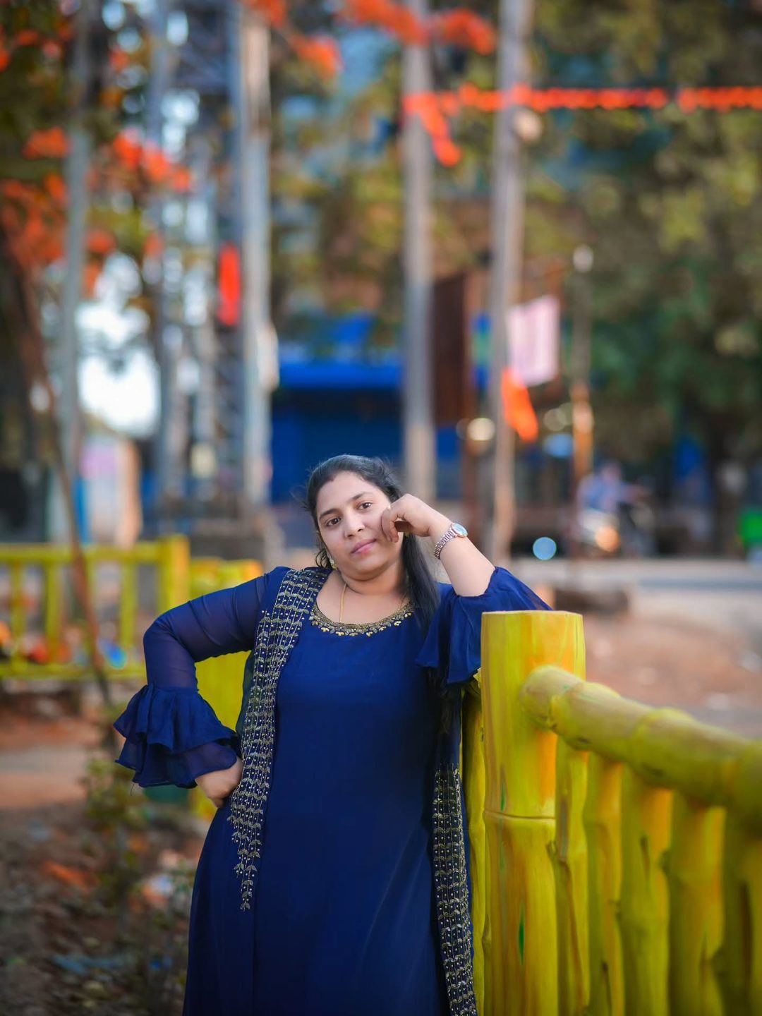 Portrait by a bamboo fence