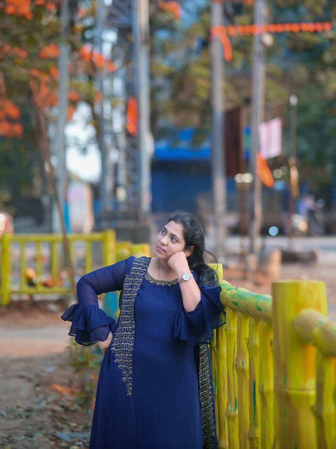 Relaxed portrait by a fence