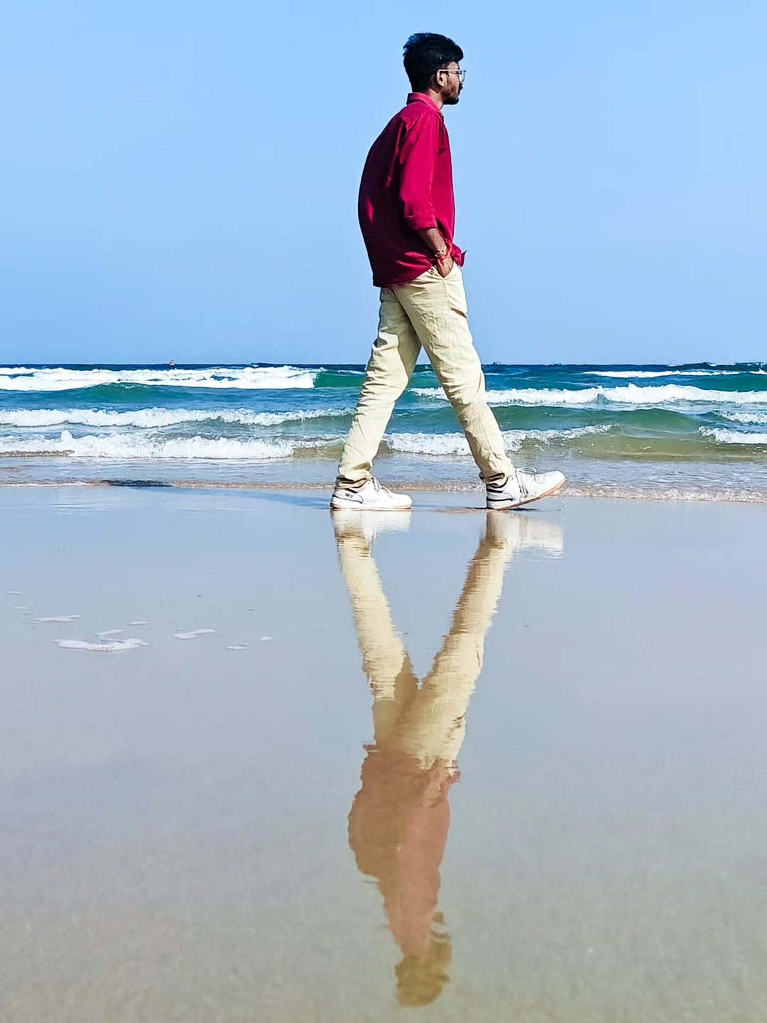 Walking shot with a reflection on wet sand